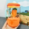 Rotating carrot juicer plush toy with cord.